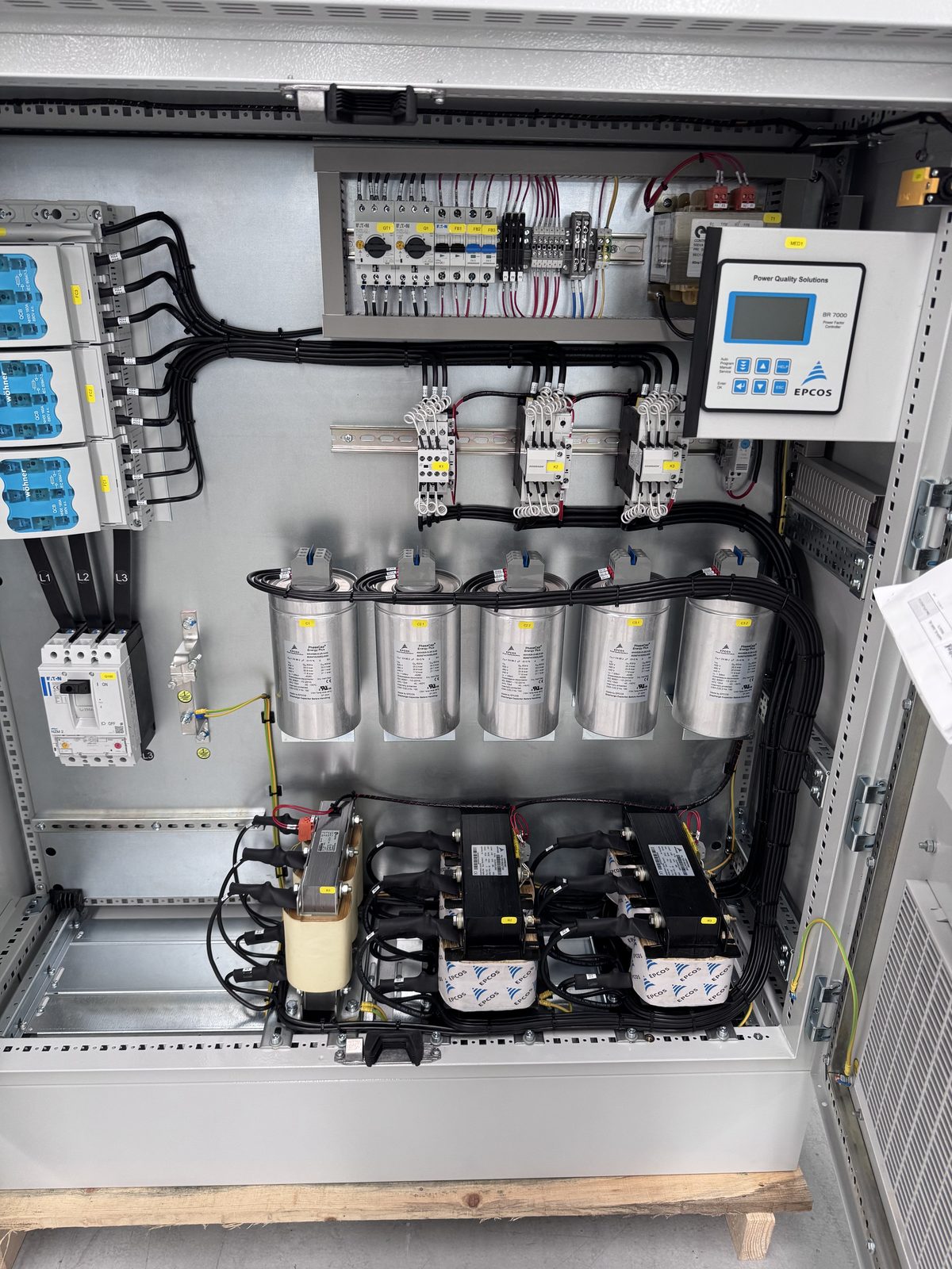 Interior de un banco de capacitores EPCOS con controlador automático de factor de potencia, contactores y fusibles
